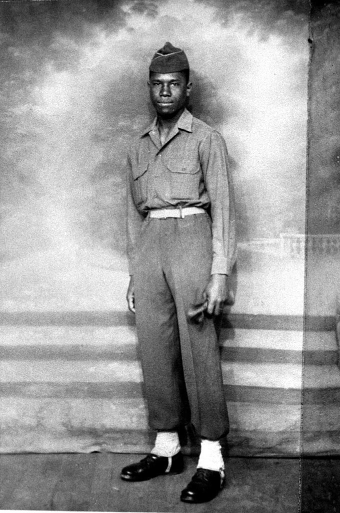 Medgar Evers poses in his military uniform in Charbourg, France