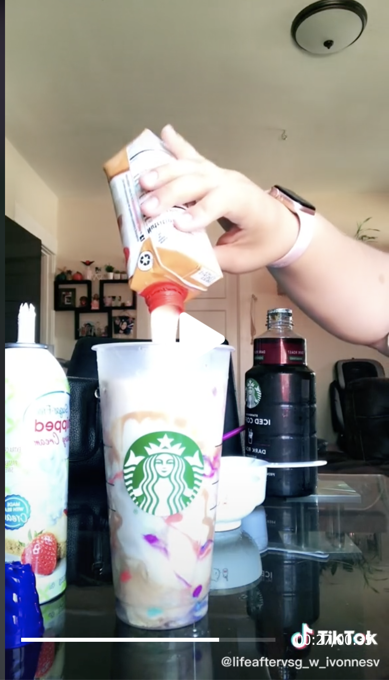 A protein shake being poured into a Starbucks cup