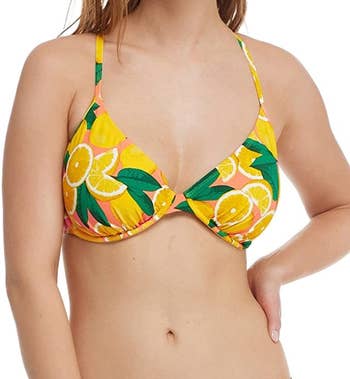 Model wearing citrus-printed bikini top