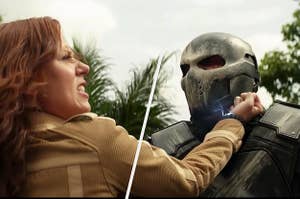 Natasha Romanoff tries to tase a bad guy wearing a metal helmet