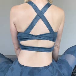back of reviewer wearing the blue top, showing the straps crossing