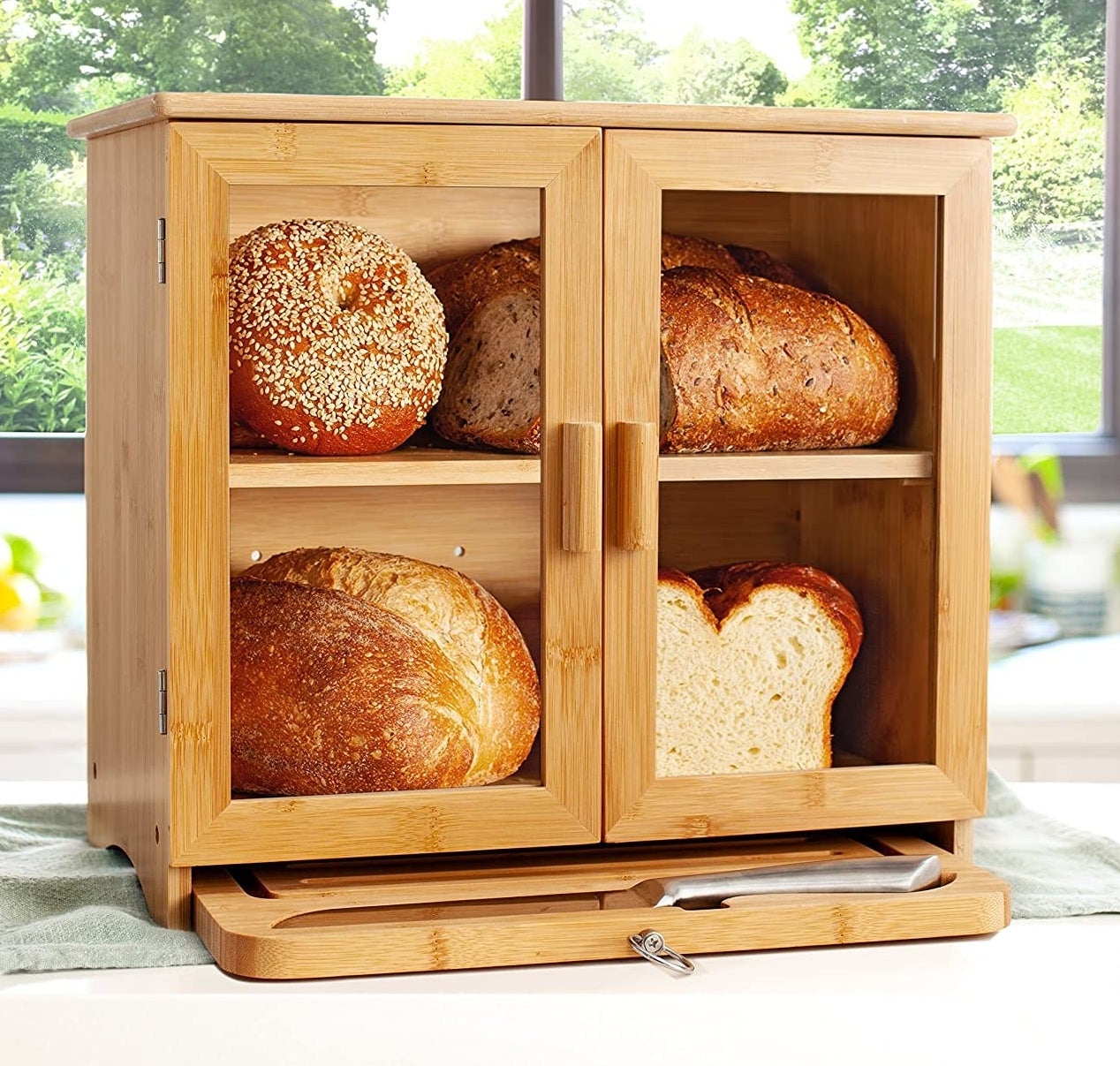 bamboo bread box with various loaves and rolls inside
