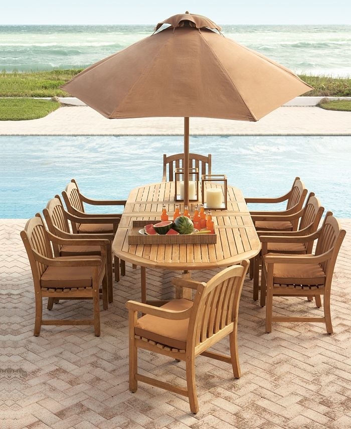 outdoor dining table with eight chairs by a pool
