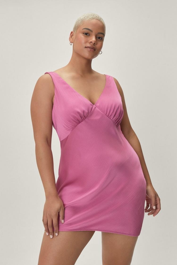 a model wearing the pink, v-neck dress
