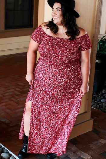 a reviewer wearing the red dress with a white floral pattern