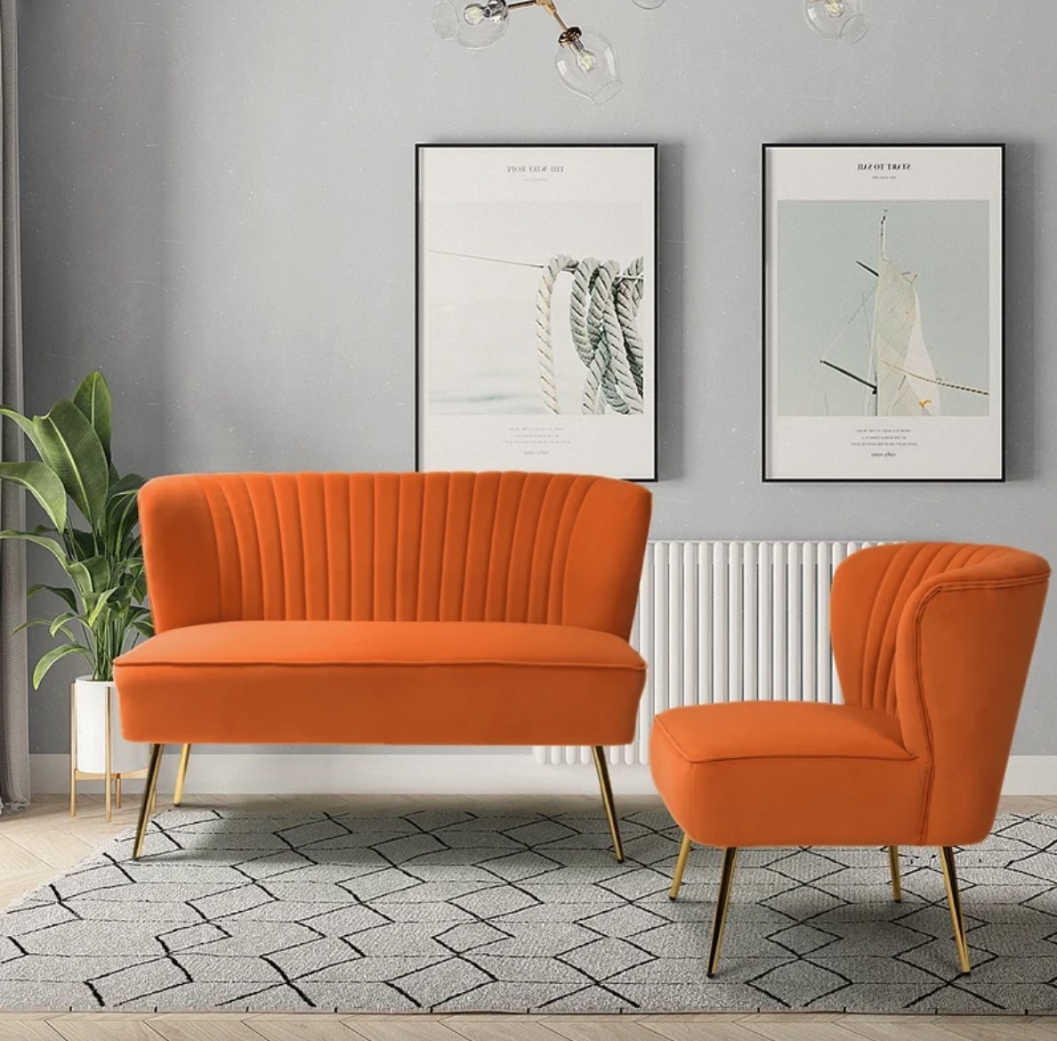 Orange loveseat with gold legs next to matching accent chair