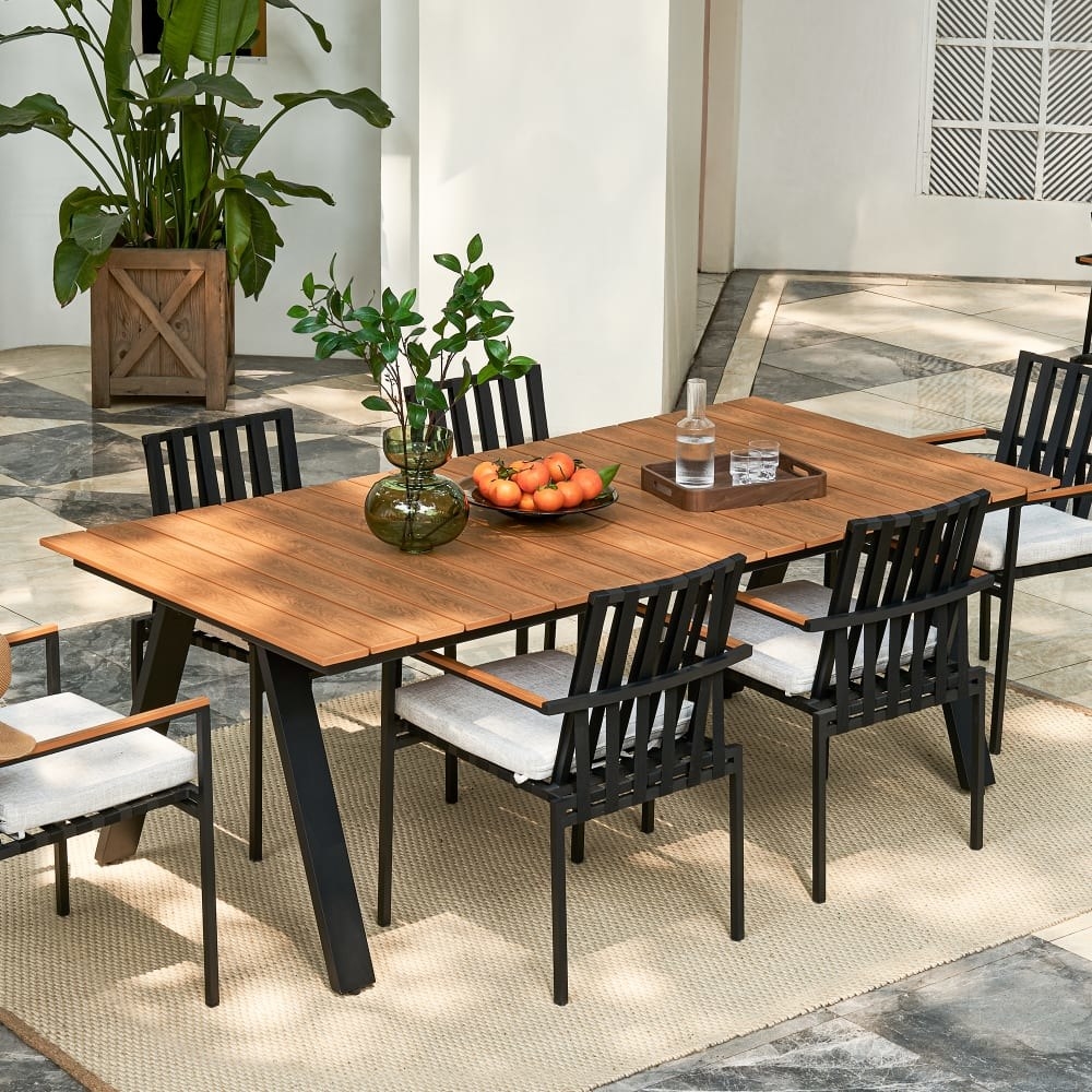 the sorrento dining table with chairs set up on a patio