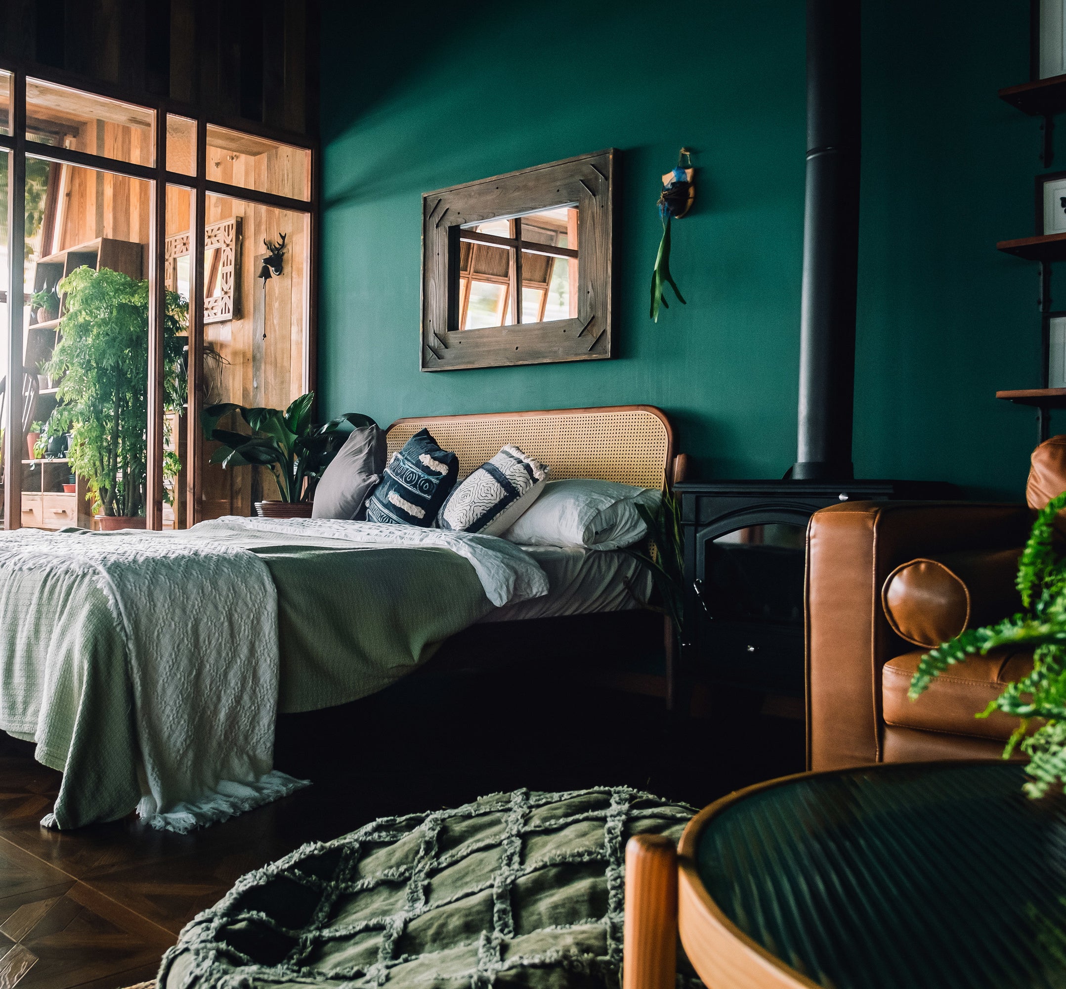 Bedroom with dark green accents and wooden furniture