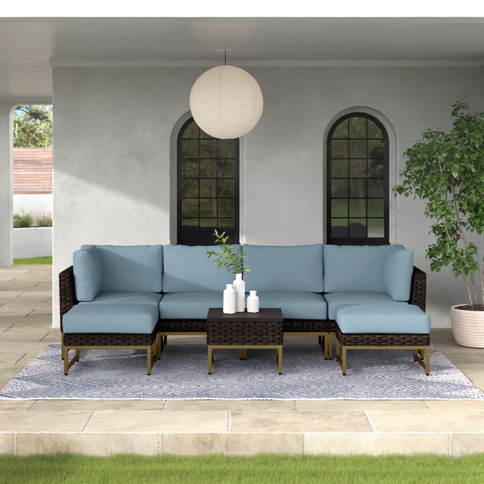 six seat wicker couch with blue cushions on a patio