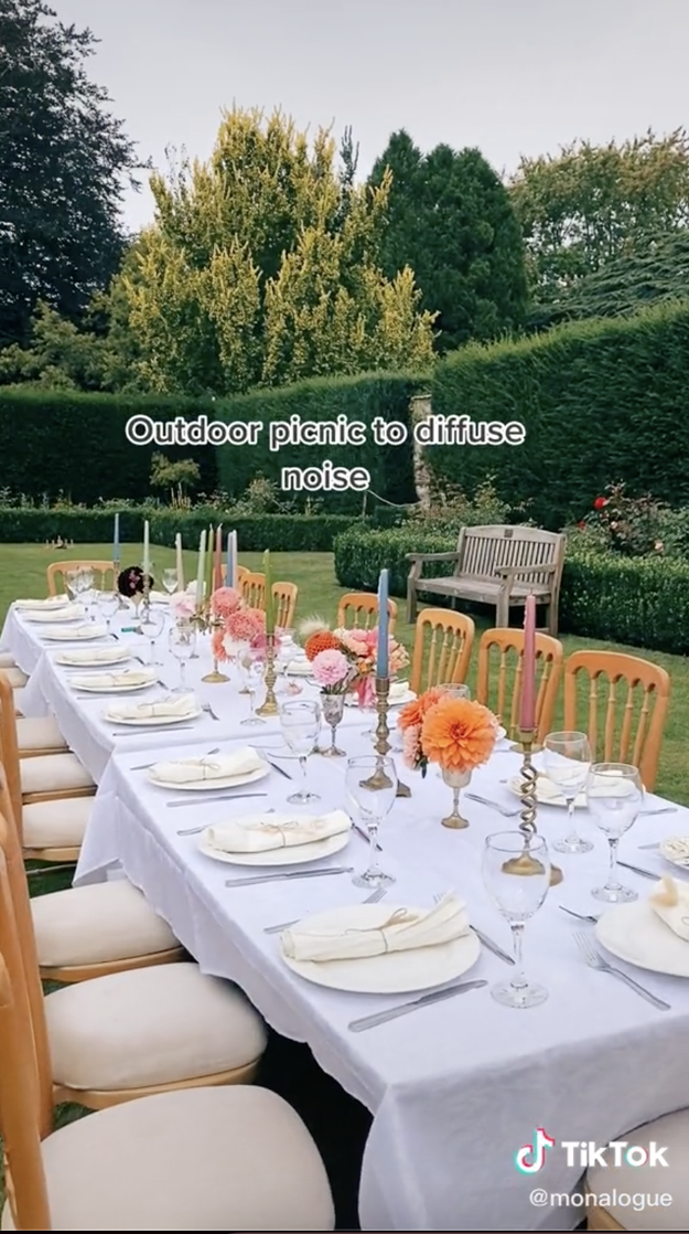 Screengrabs of a TikTok by user monalogue on a table lined with chairs outside and the caption &quot;Outdoor picnic to diffuse noise&quot;