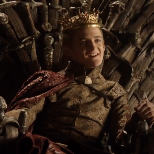 Joffrey sitting on the Iron Throne looking smug