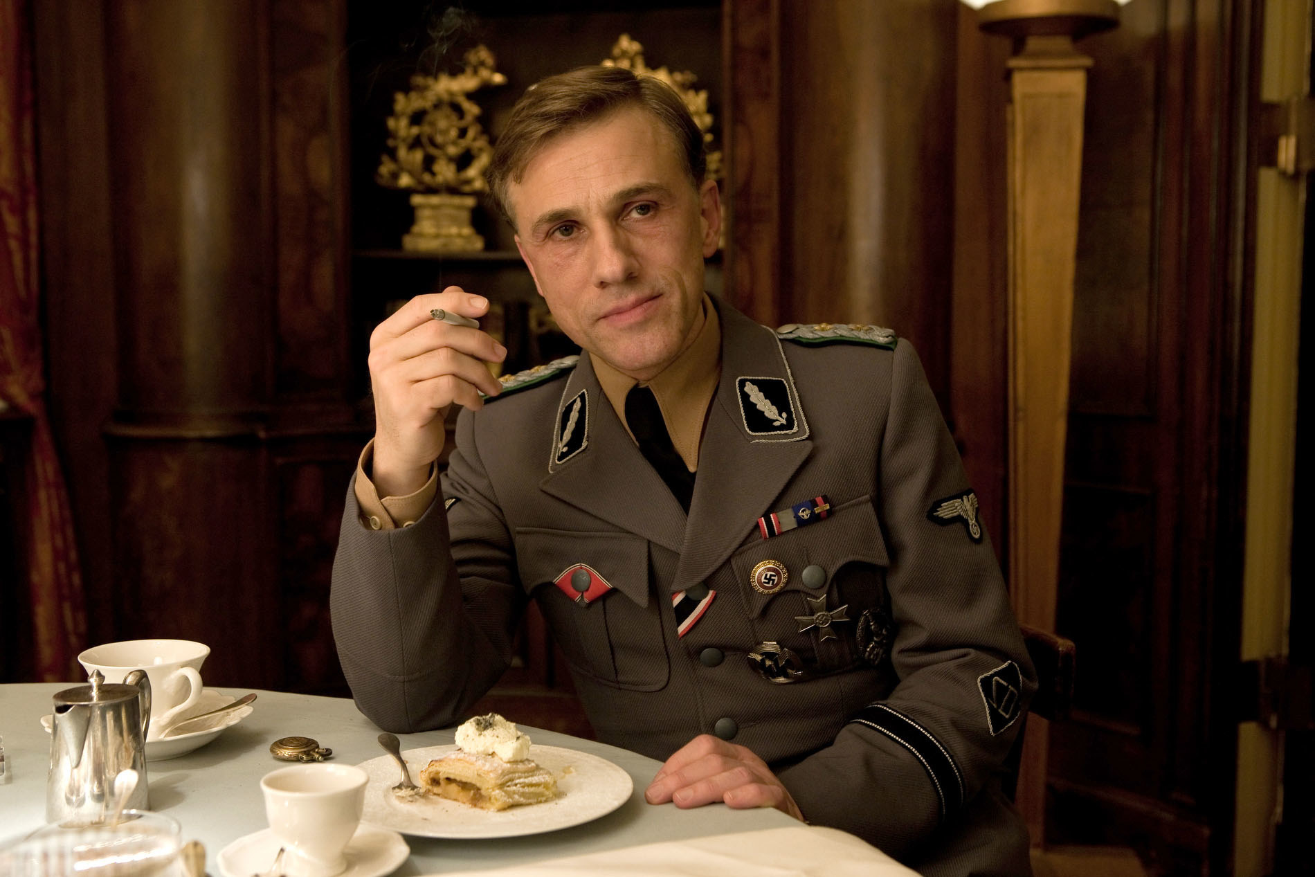 Christoph Waltz sitting at a dinner table
