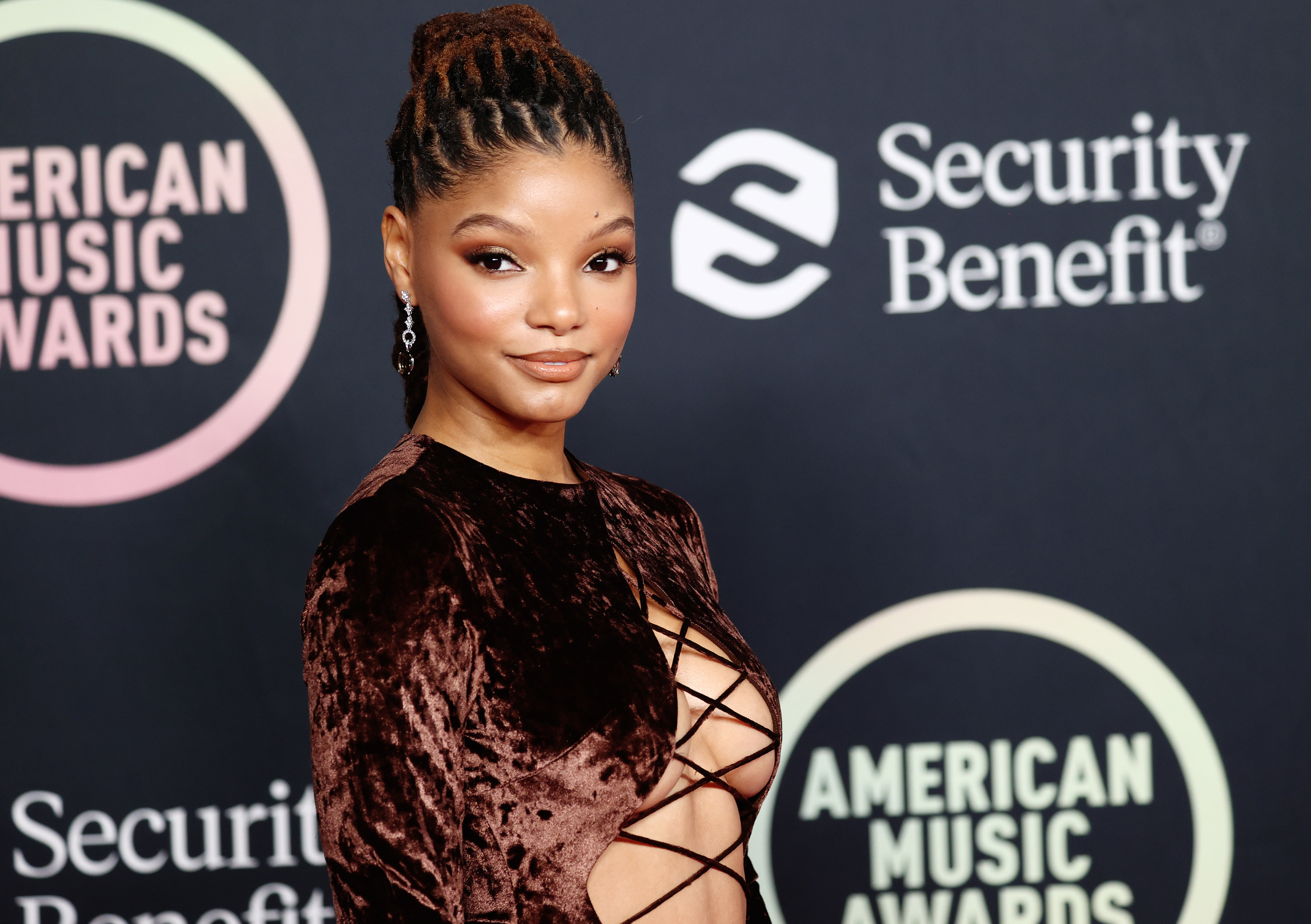 Halle Bailey poses at a step-and-repeat