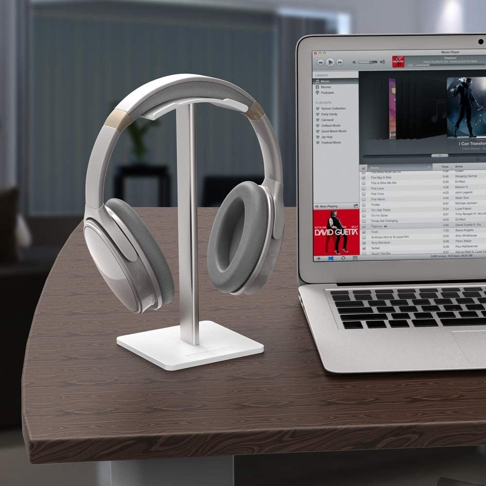 Headphones on the stand next to a laptop
