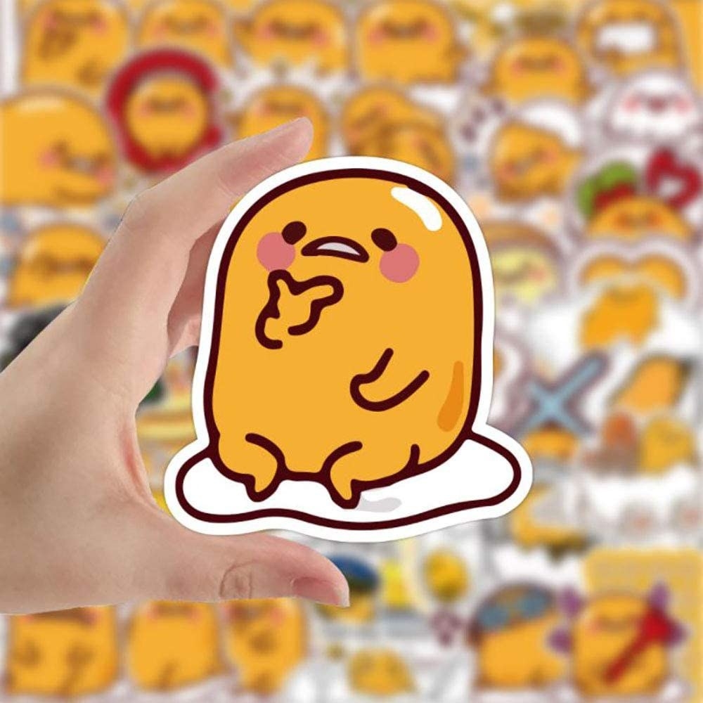 Someone holding up a sticker of a fried egg with a face, that appears to be thinking