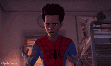 Miles Morales looking at his hands in a scene from Into the Spiderverse
