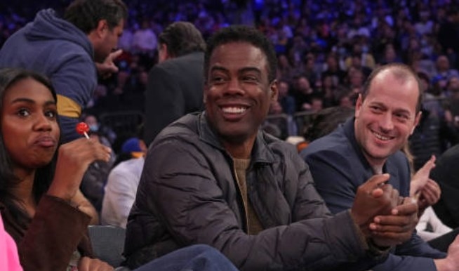 Chris Rock watches an NBA game between the Golden State Warriors and the New York Knicks in December 2021