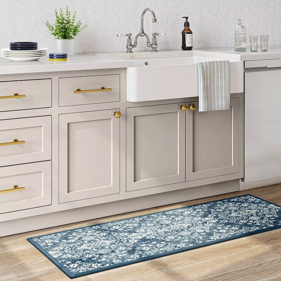 Blue and white runner rug next to a kitchen sink