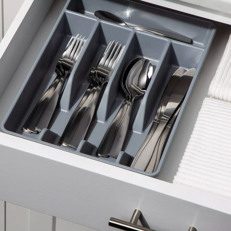 Gray drawer organizer filled with silverware