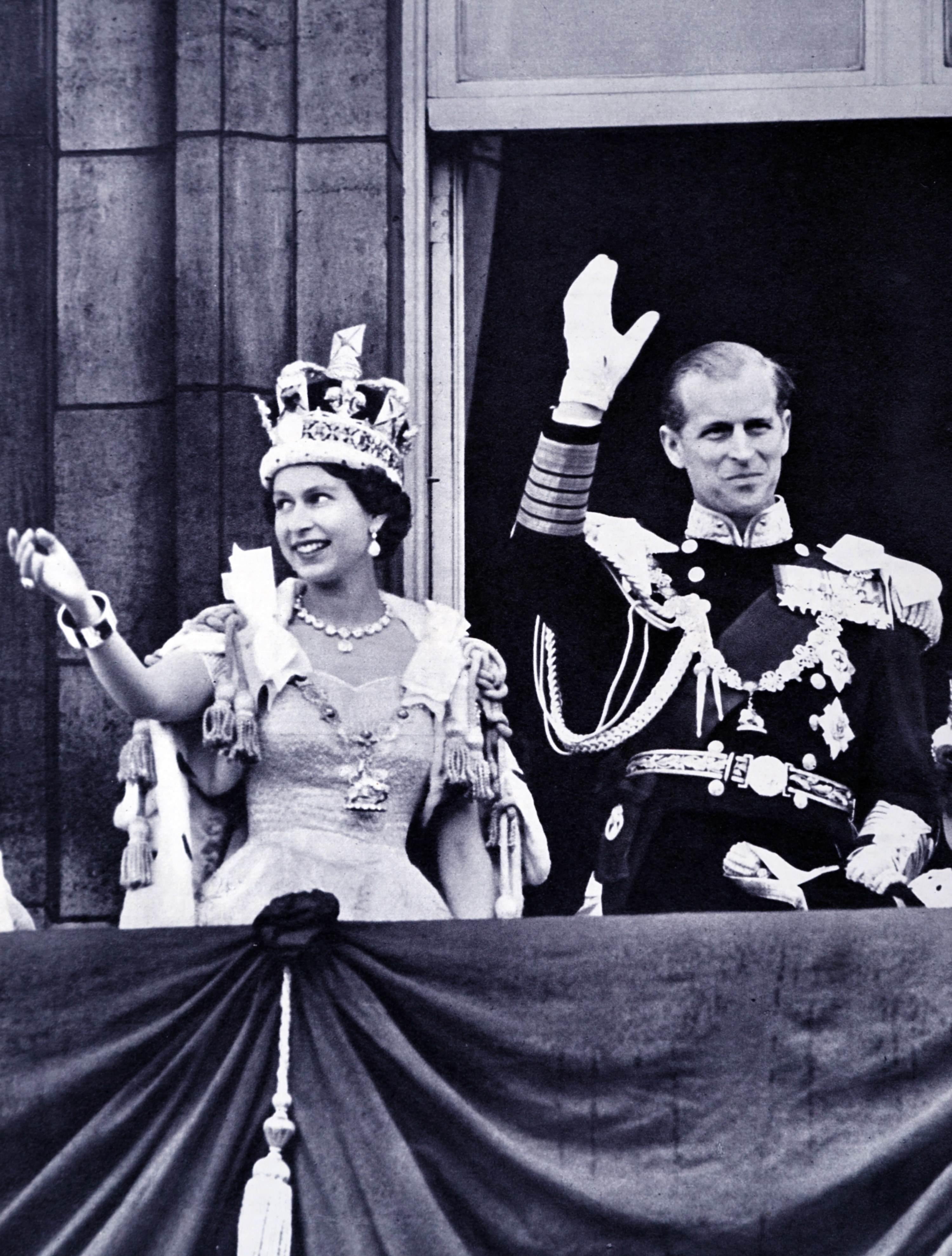 Queen Elizabeth and Prince Philip wave