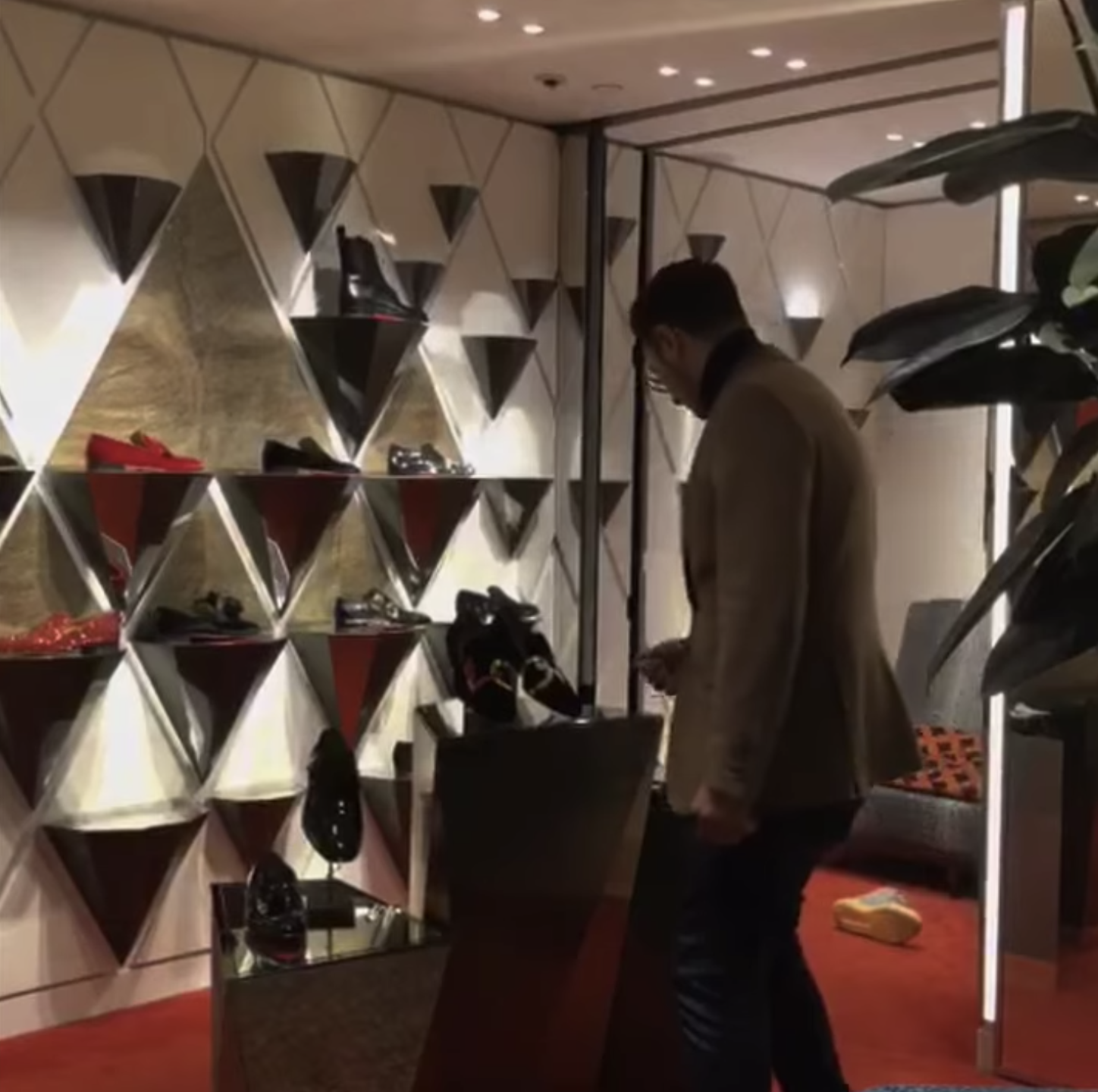 Simon looking at shoes in a store