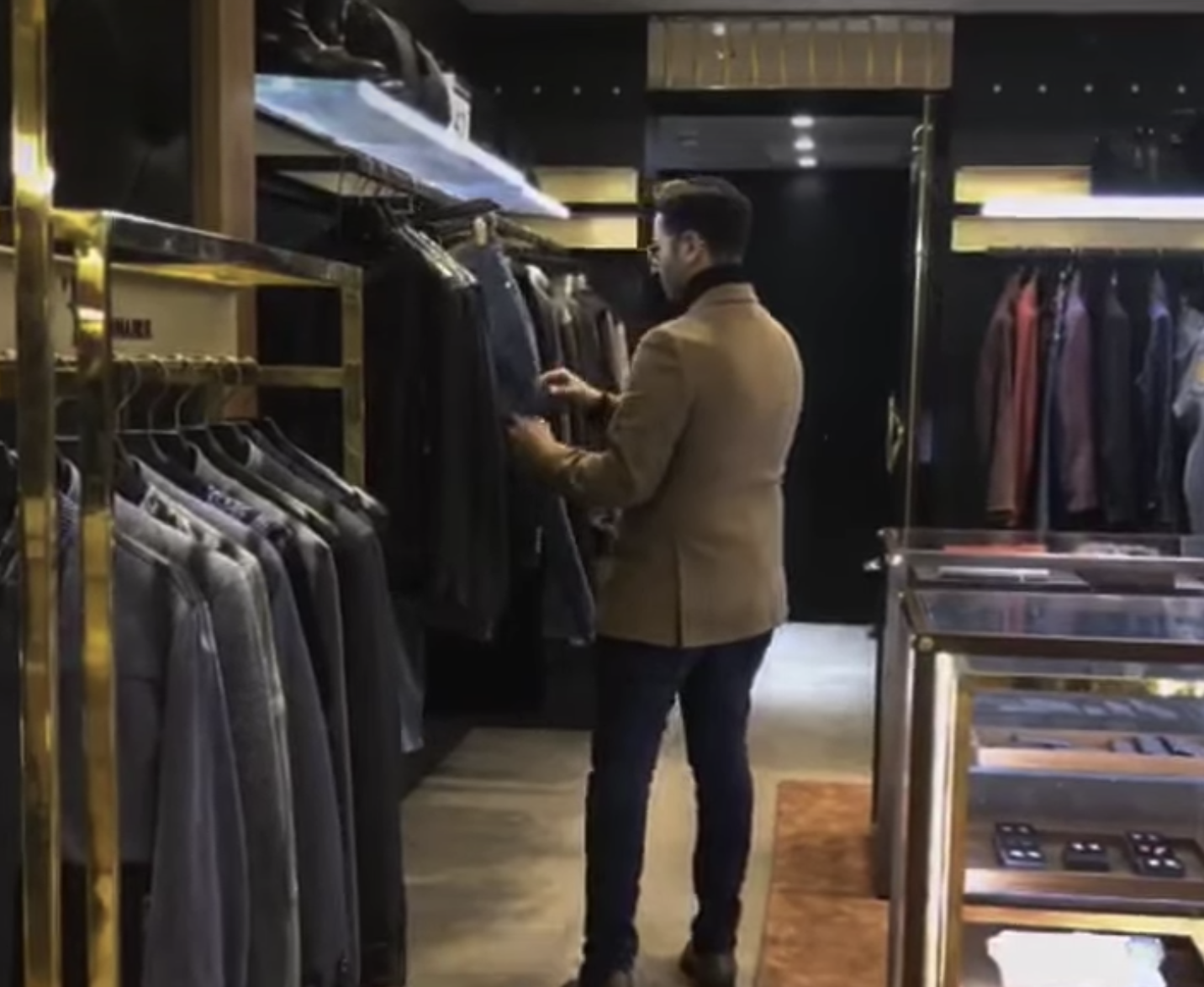 Simon looking at pants in a clothing store