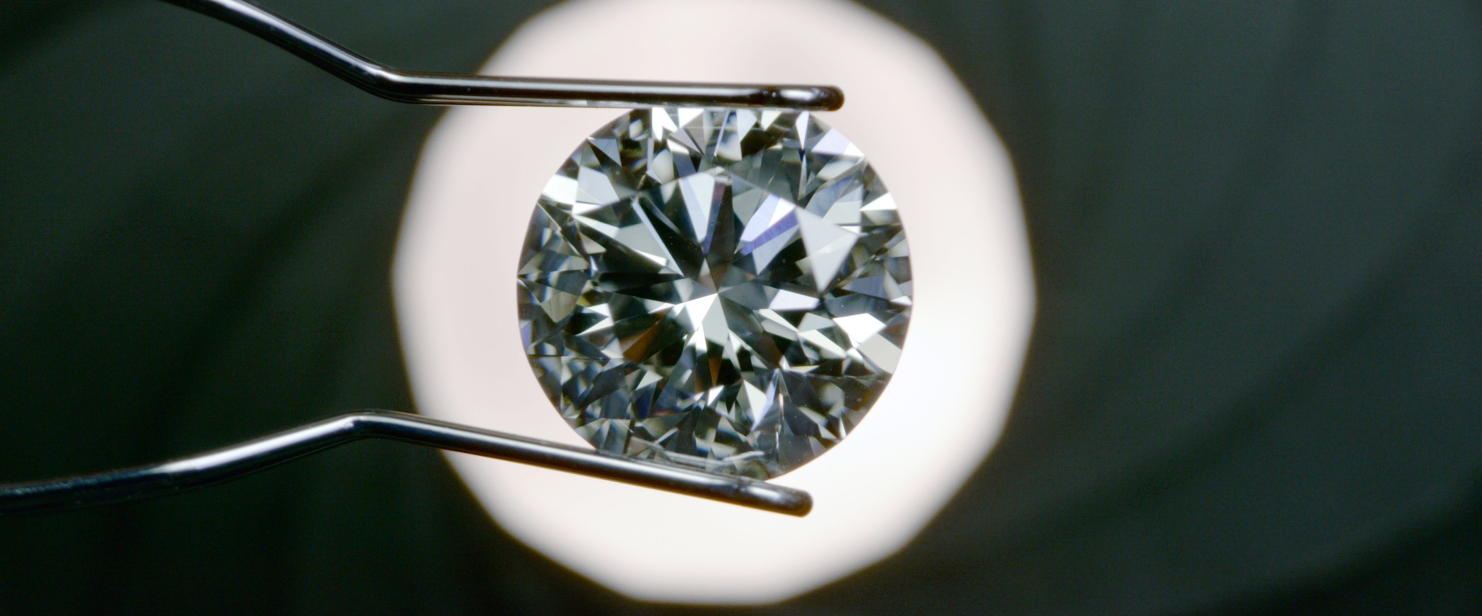 A close-up of a diamond being examined