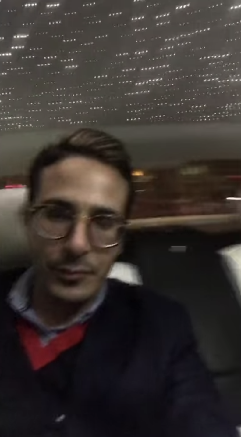 A blurry image of Simon who wears eyeglasses