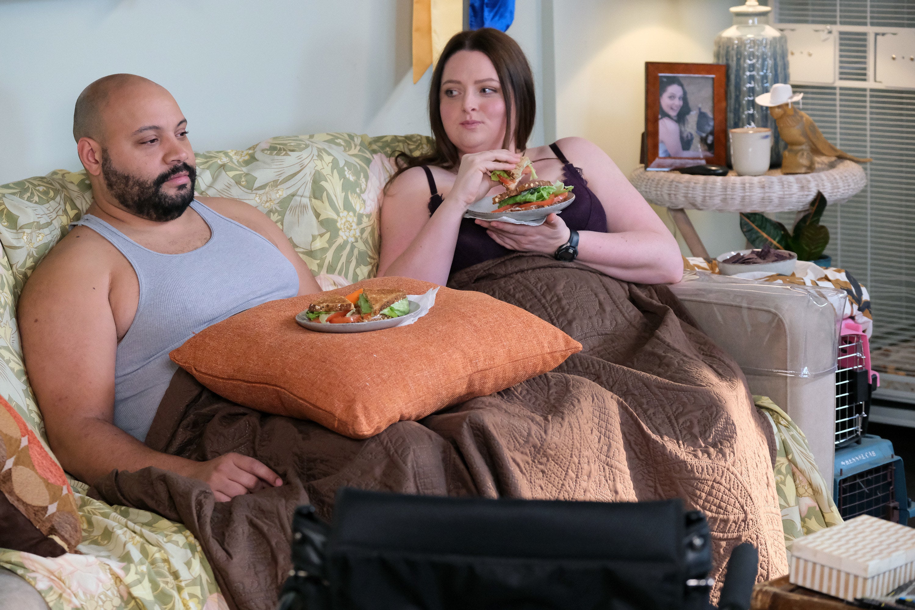Dina and Garrett eating a salad on the couch