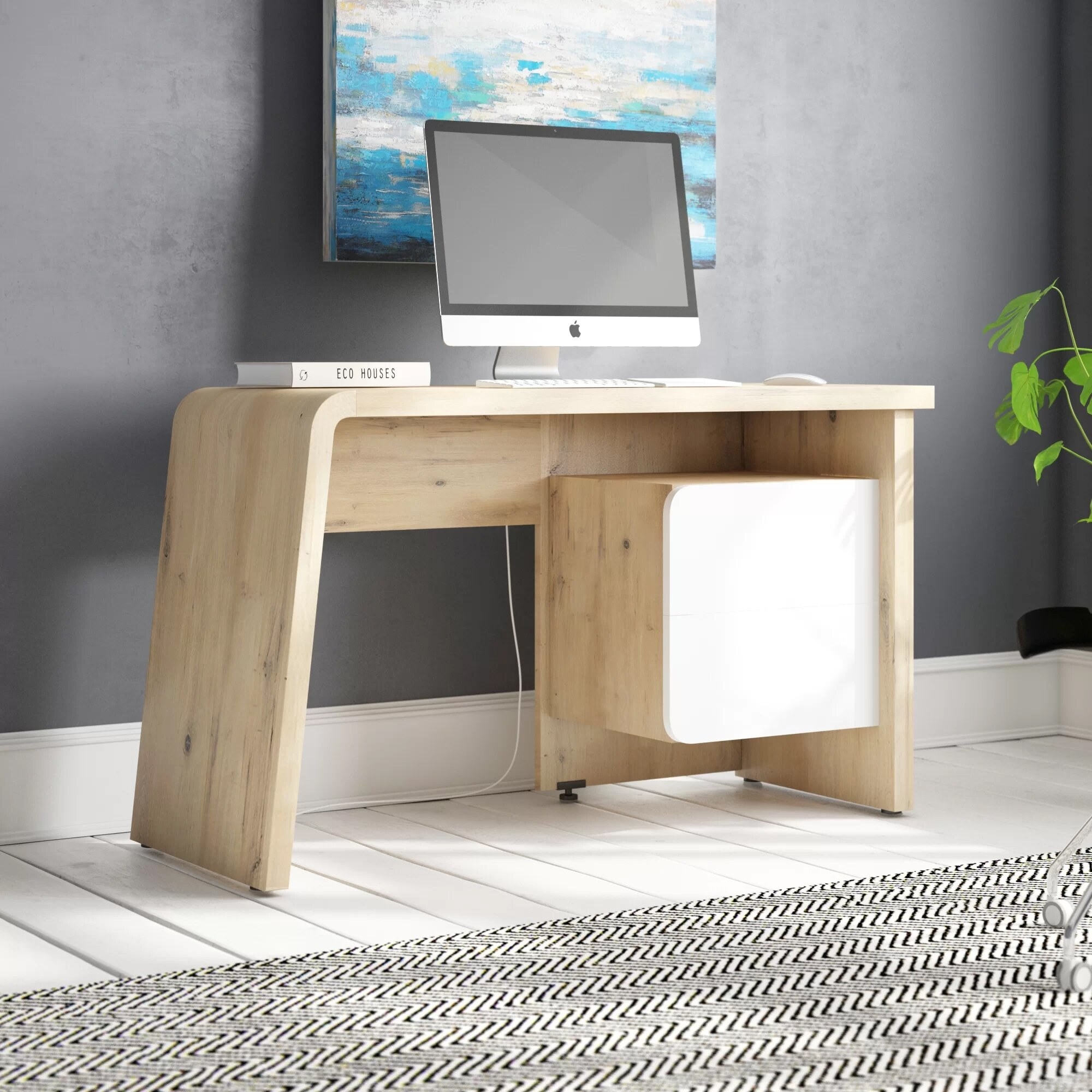 A minimalist desk with a white cabinet.