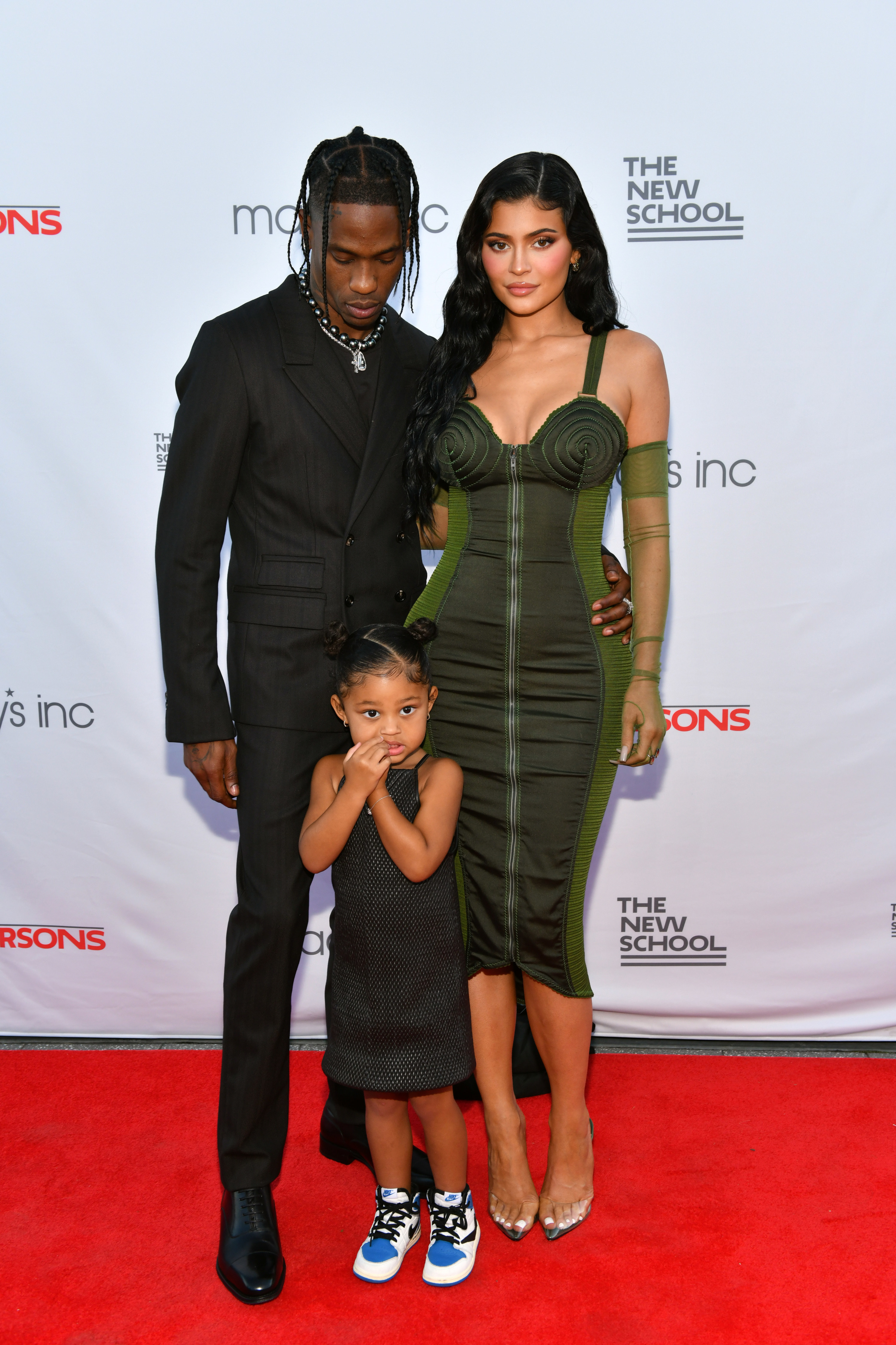 Travis, Kylie, and Stormi Webster pose for a photo on the red carpet