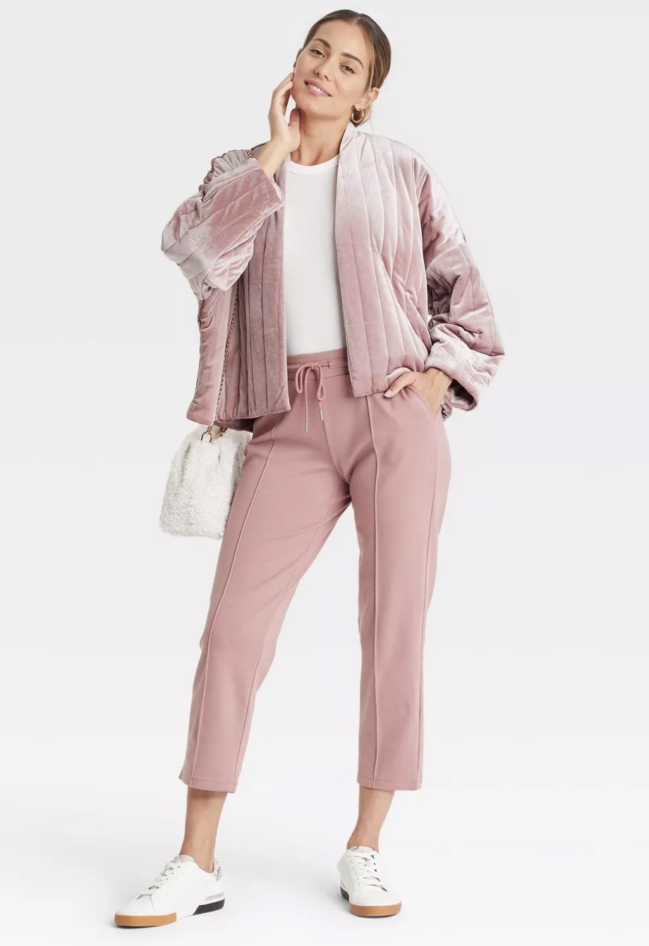 The open soft jacket is light pink with vertical pleats and is a light bubblegum pink
