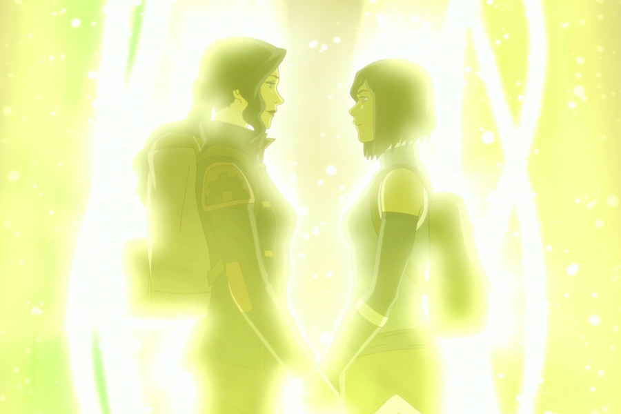 Korra and Asami facing each other and holding hands, while surrounded by yellow light