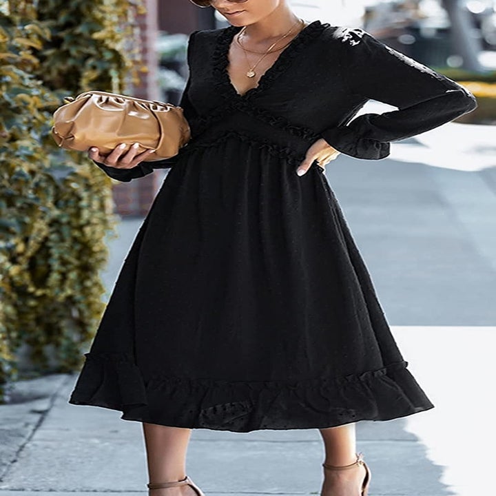 A model wearing the black dress