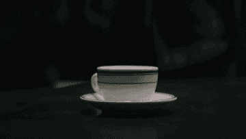 close up gif of a cup of coffee with a question mark drawn inside