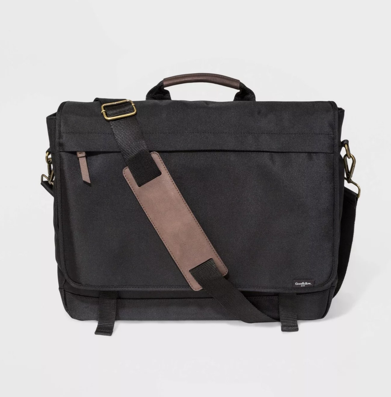 The black messenger bag has a light brown accent on the front zipper pocket, handle and strap