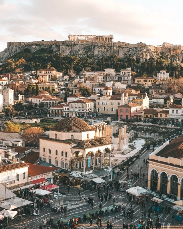 A view of the Parthenon in the distance over buildings in Athens