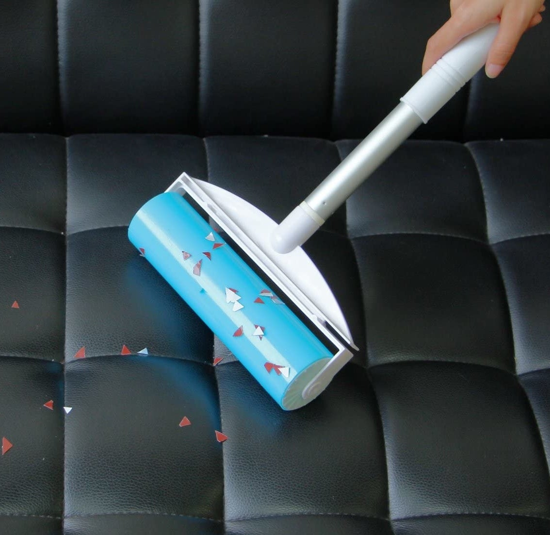 a person using the gel roller to pick up confetti