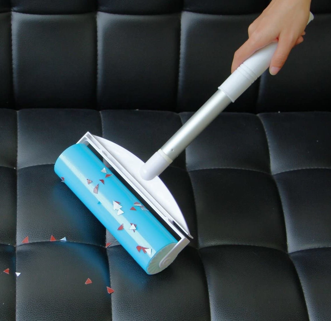 a person using the gel roller to pick up confetti