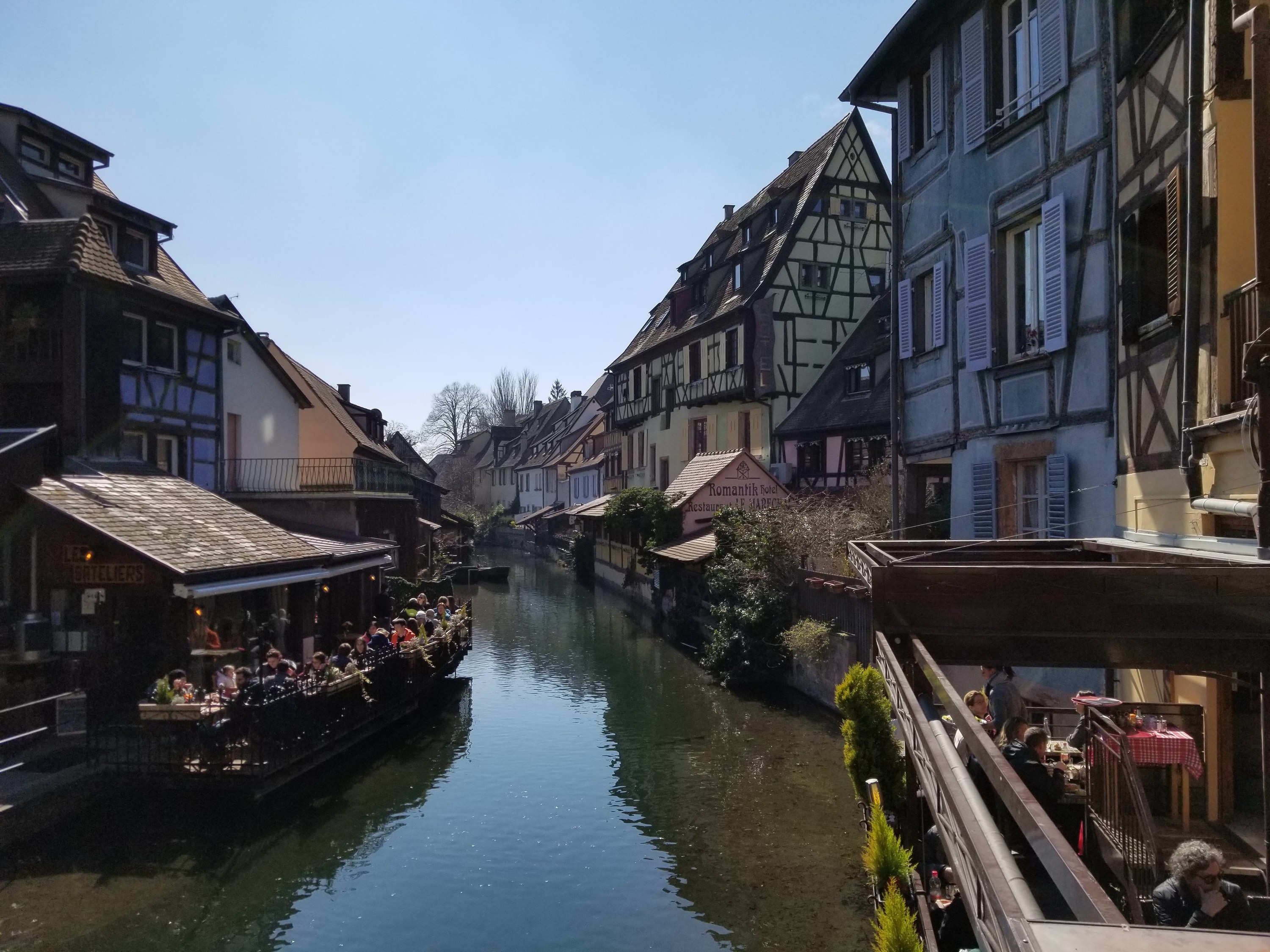 Restaurants alongside a canal through a picturesque Colmar