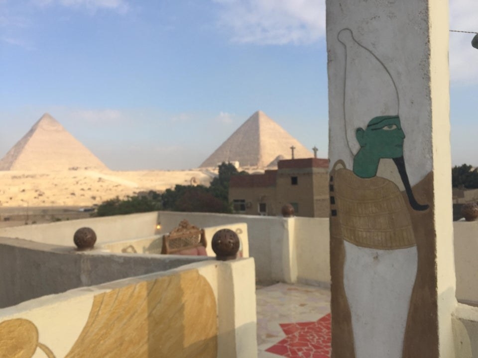 the Pyramids of Giza in the distance from the patio of an Airbnb