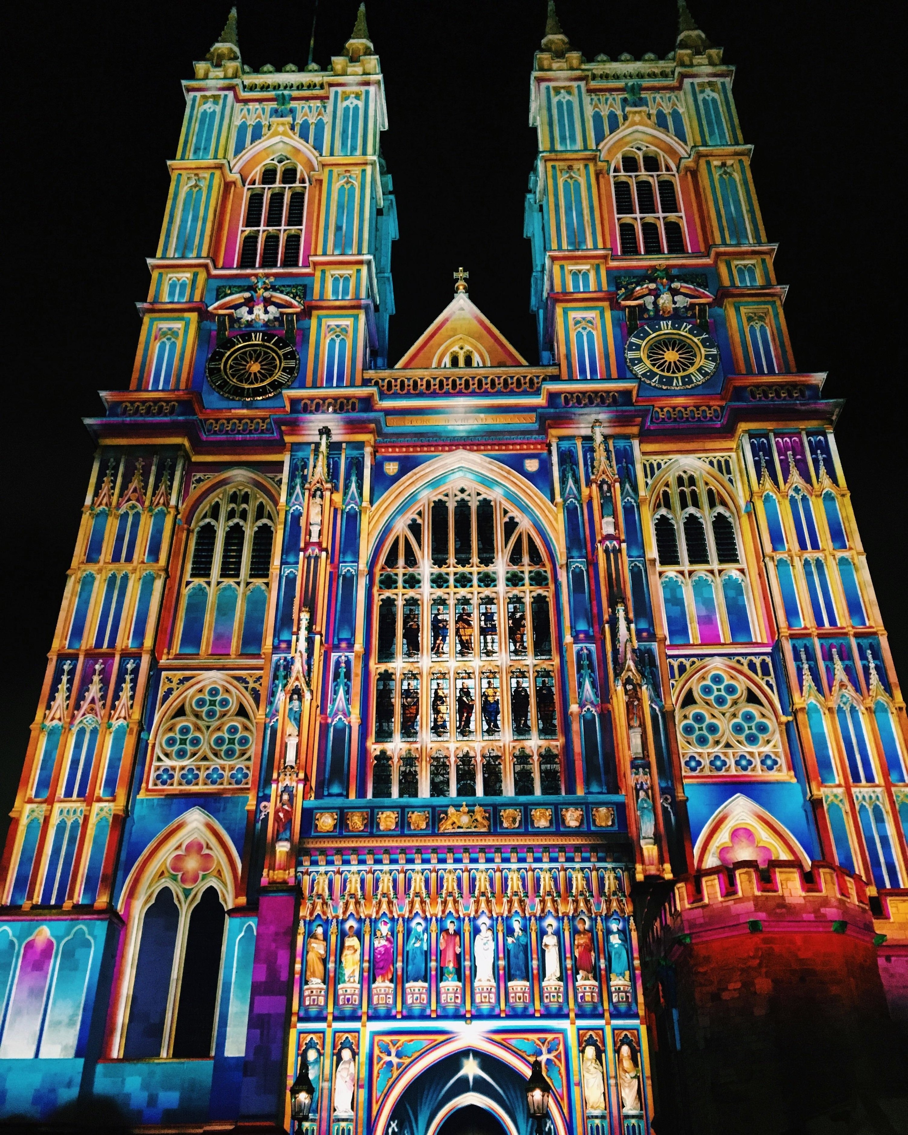 the Westminster Abbey lit up to look like stained glass in London