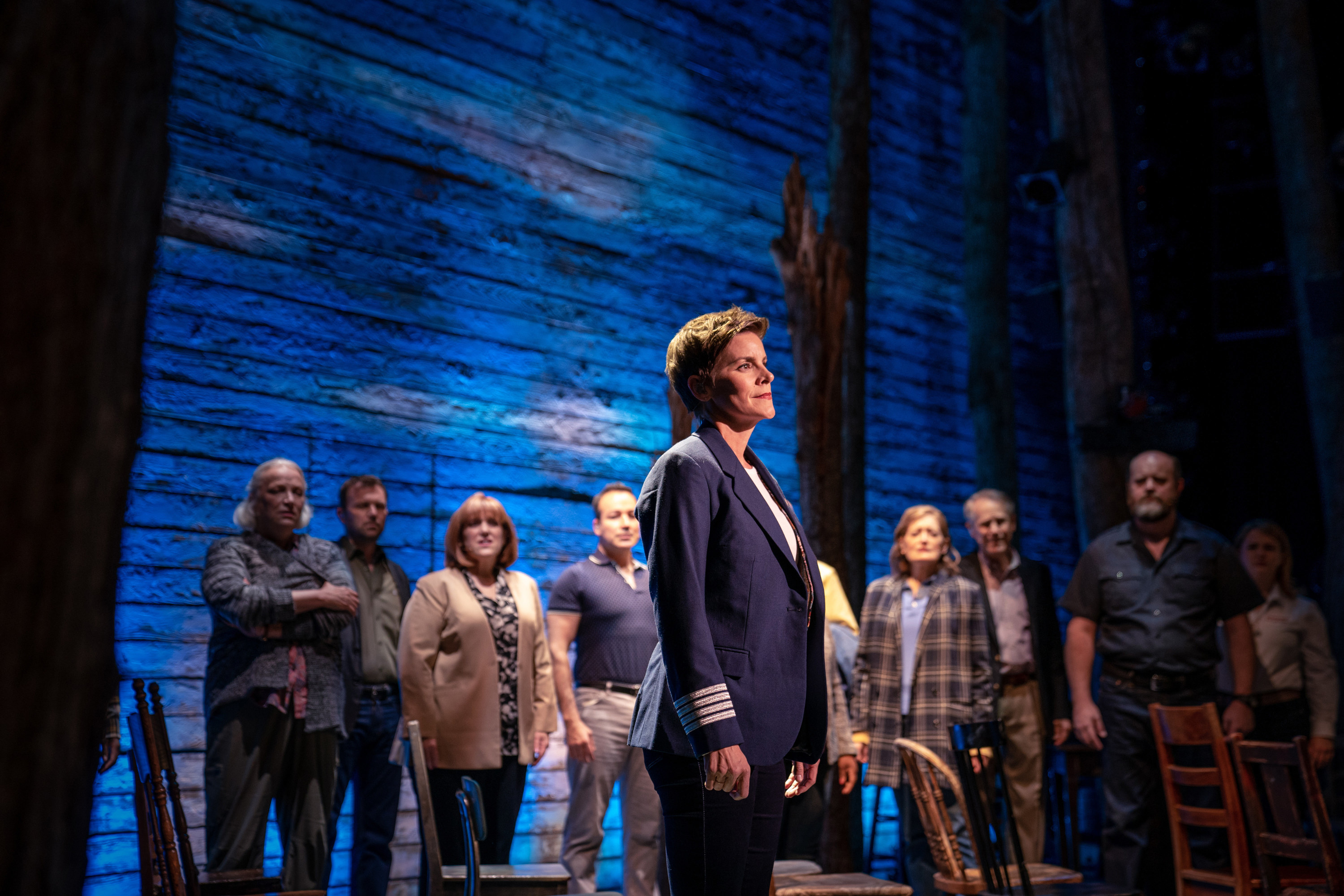 The cast stands onstage