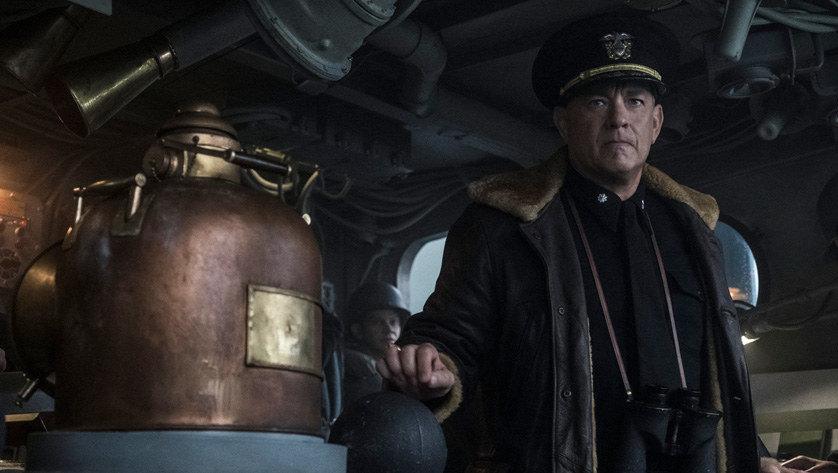 Tom Hanks stands in the hull of a ship