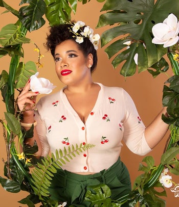 reviewer wearing the white sweater