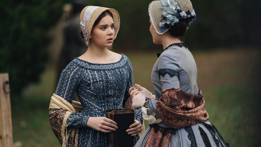 Hailee Steinfeld carries a book and talks to a friend