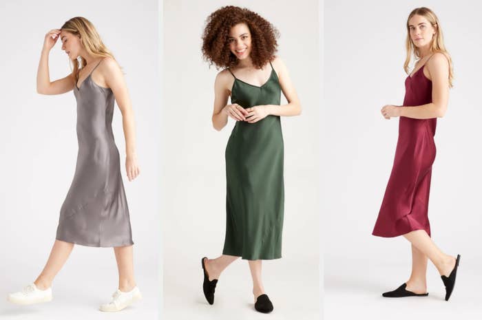 Three models wearing silk slip dresses