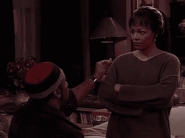 Shaun Baker as Russell Montego holds up a ring to Kim Fields as Regine Hunter in &quot;Living Single&quot;