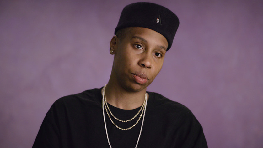 Lena Waithe sits in front of a purple wall