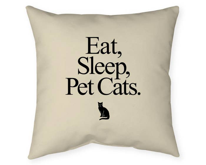 &quot;Eat, sleep, pet cats&quot; beige pillow with black writing, image of cat